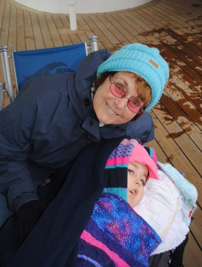 A young Kennedy and her grandmother, both dressed warmly on the deck of a ship in Alaska.