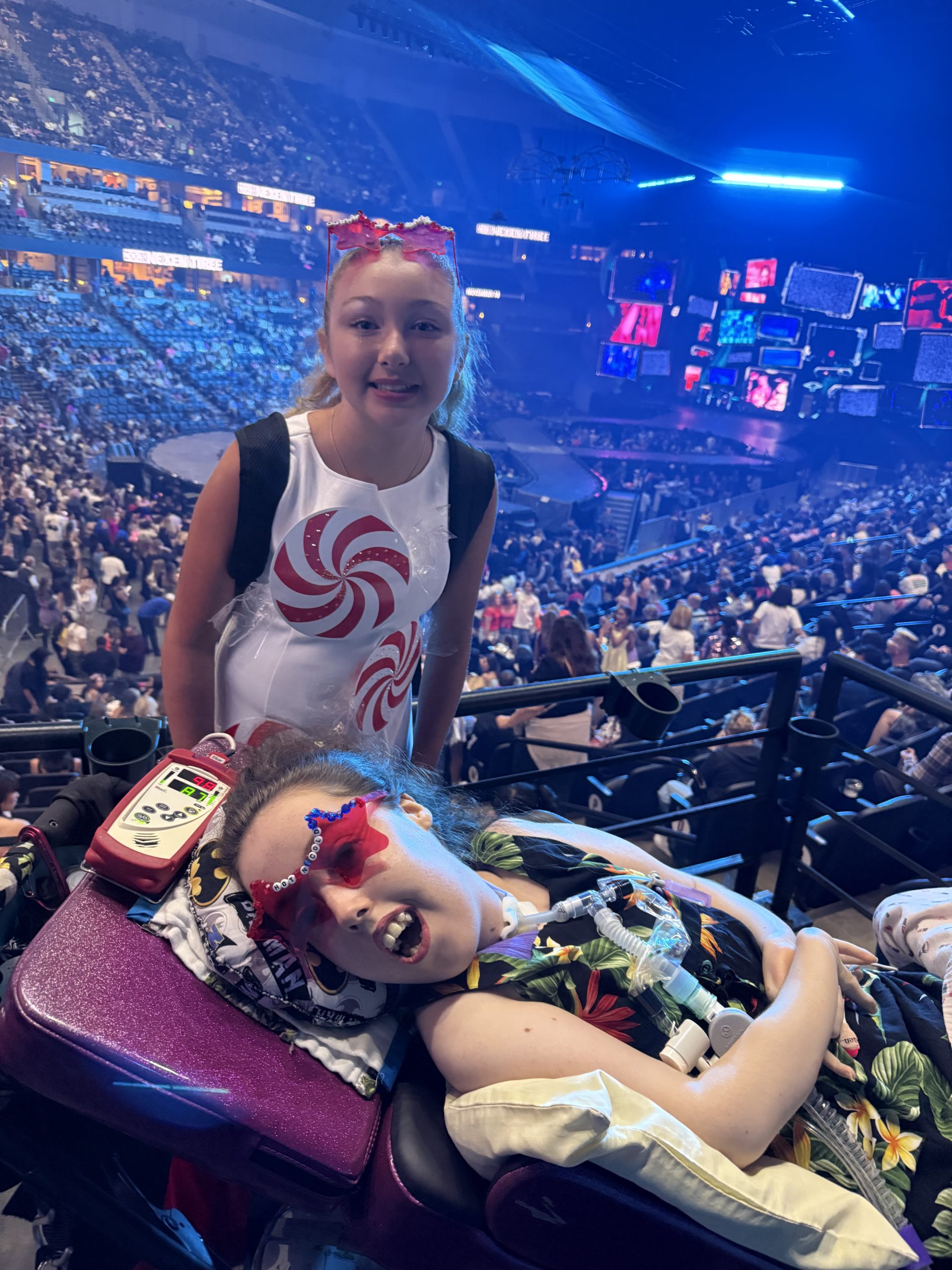 Kennedy, in a wheelchair, with her friend at a concert.