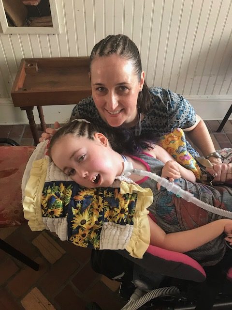 Kennedy and Jennifer Swann smiling together with Jamaican Braids in their hair.