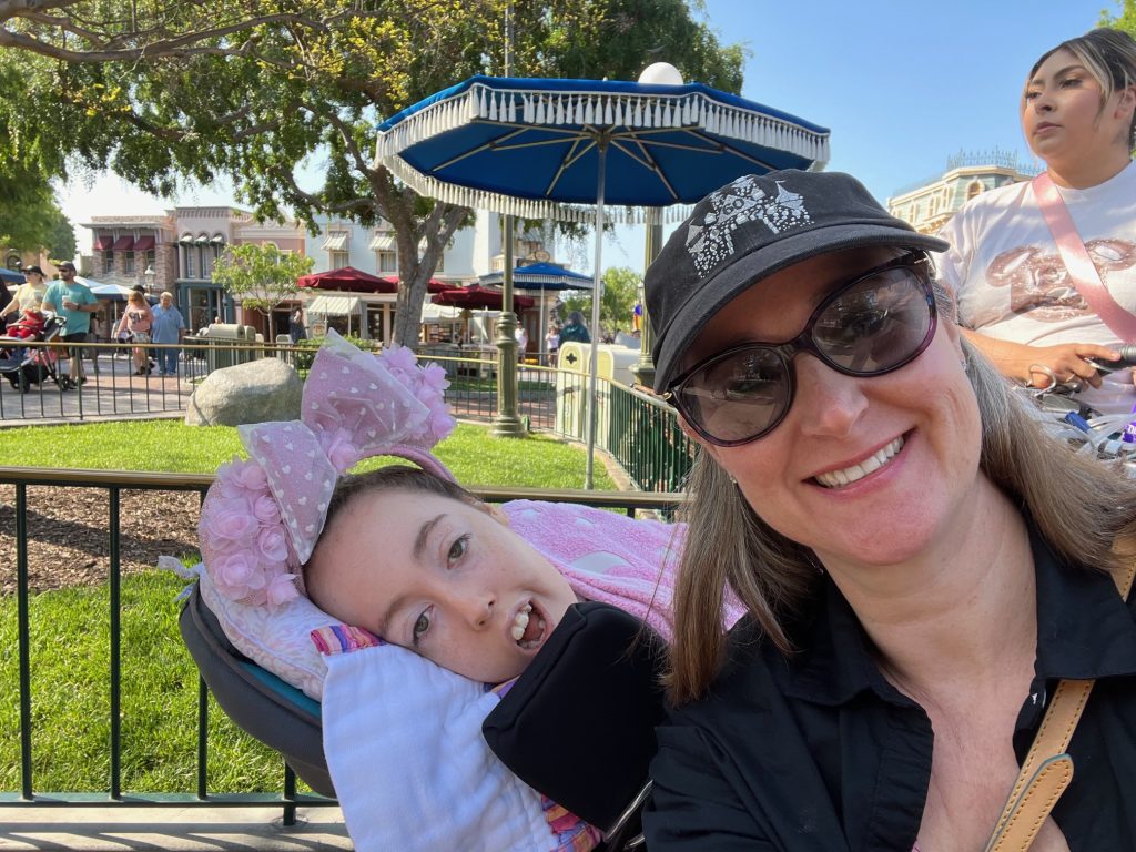 Jennifer Swann and Kennedy posing together on a sunny day at Disney World.