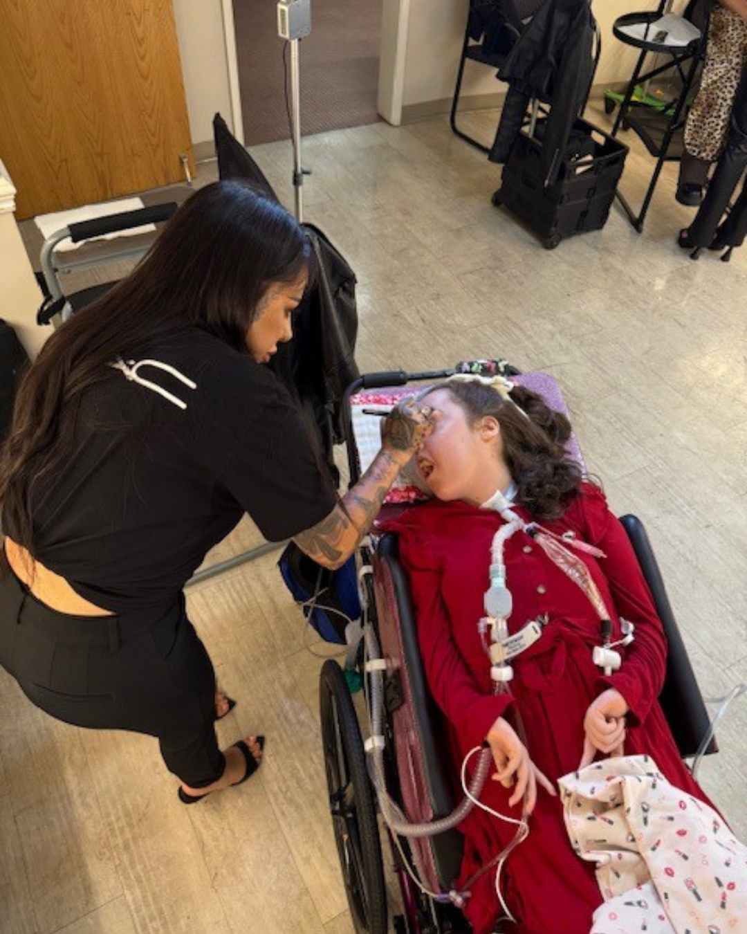 Makeup artist gently applying makeup during an in-home care visit.
